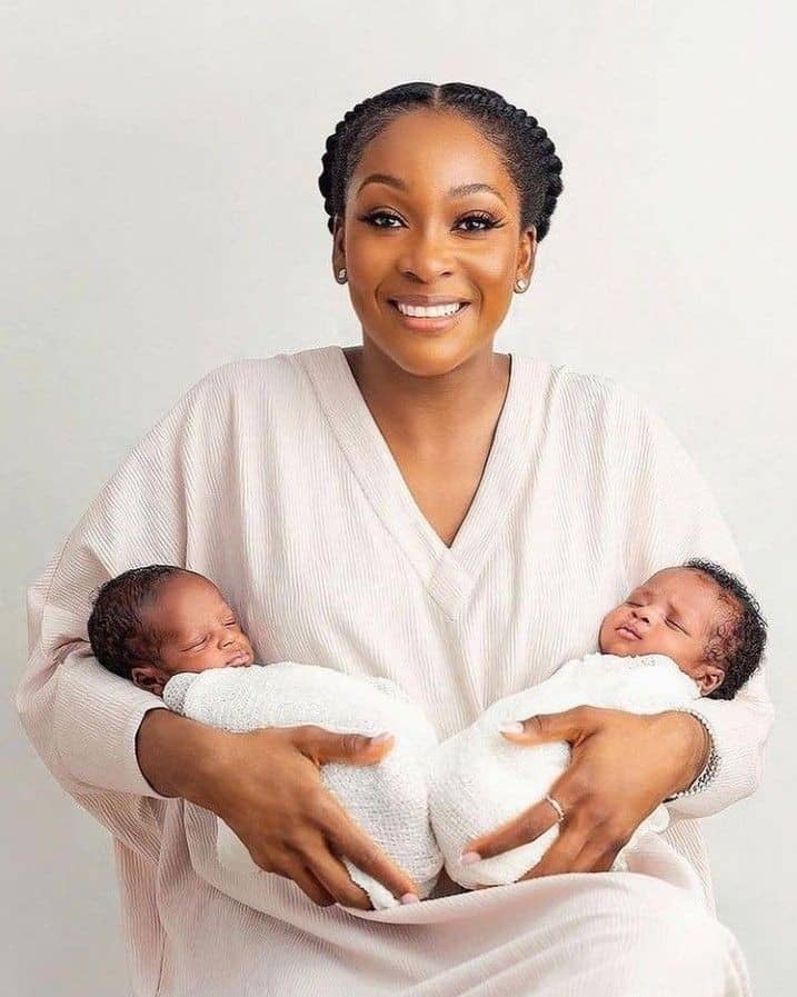 Joyful mother holding her newborn twins